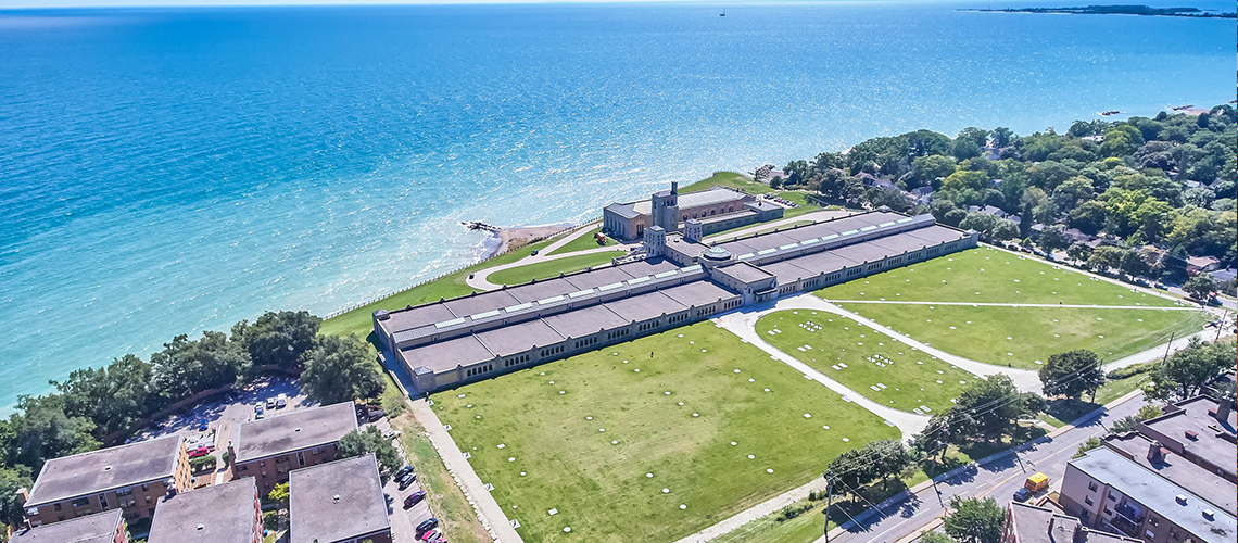 Aerial view of a historic lakeshore building beside Lake Ontario